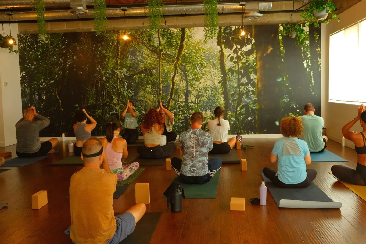 Men and women practicing together in a class at Half Pigeon Yoga in St. Petersburg